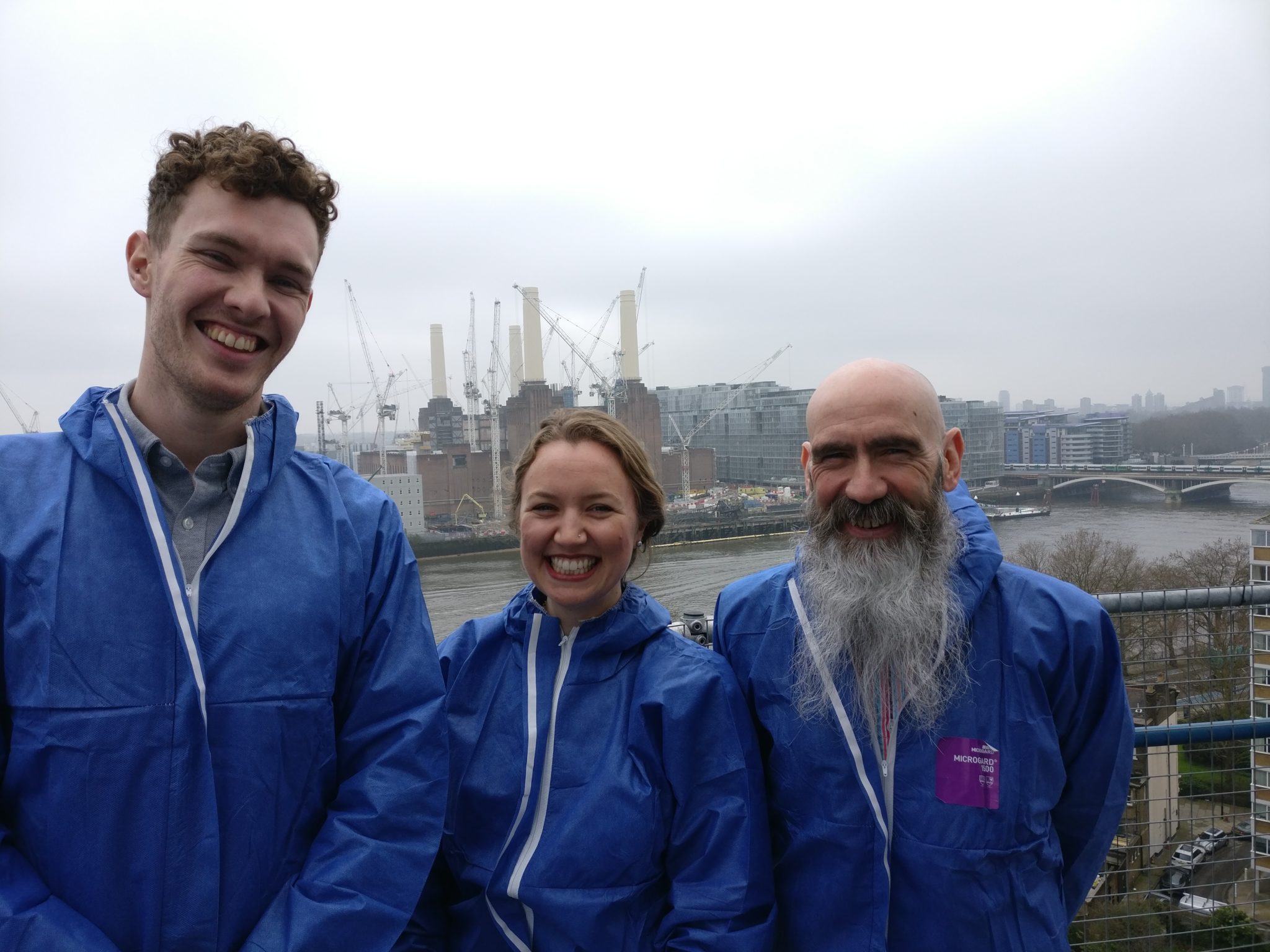 Members of the Energetik team standing on top of PDHU's accumulator tower with a view of Battersea Power Station in the background